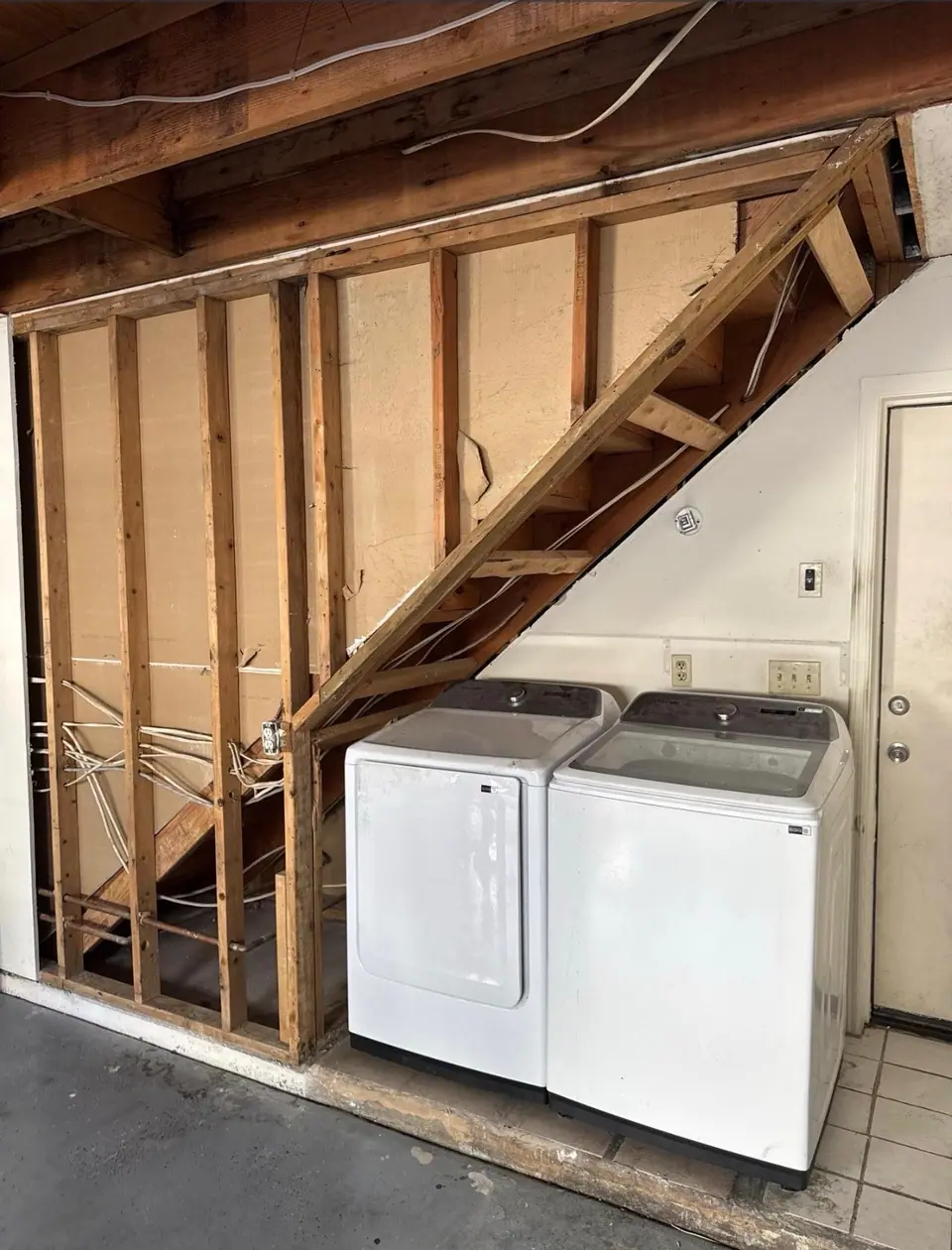 A laundry room opened to the studs so the framing can dry