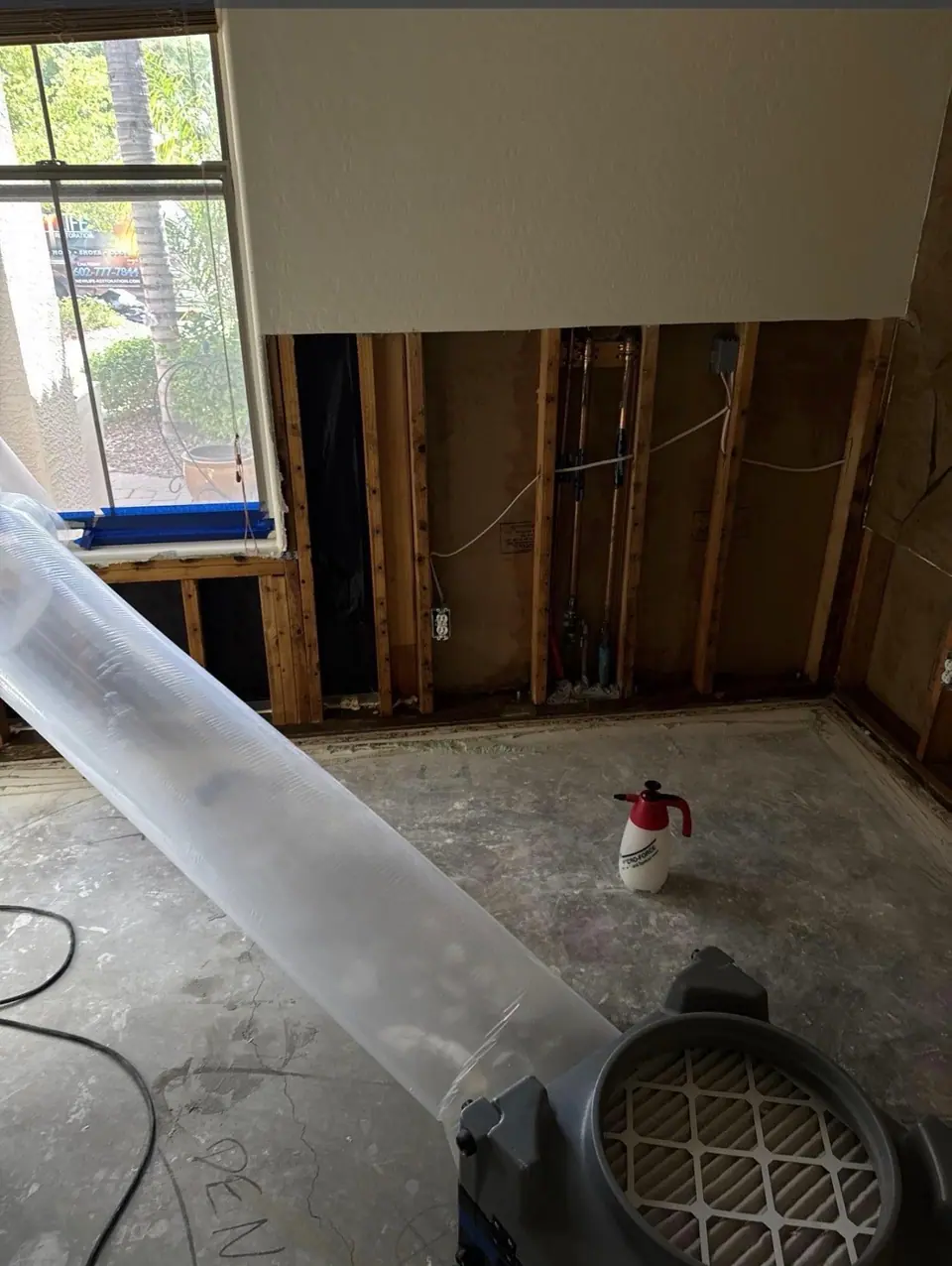 Drywall cut out two feet up the wall and an air scrubber running on one of our water jobs
